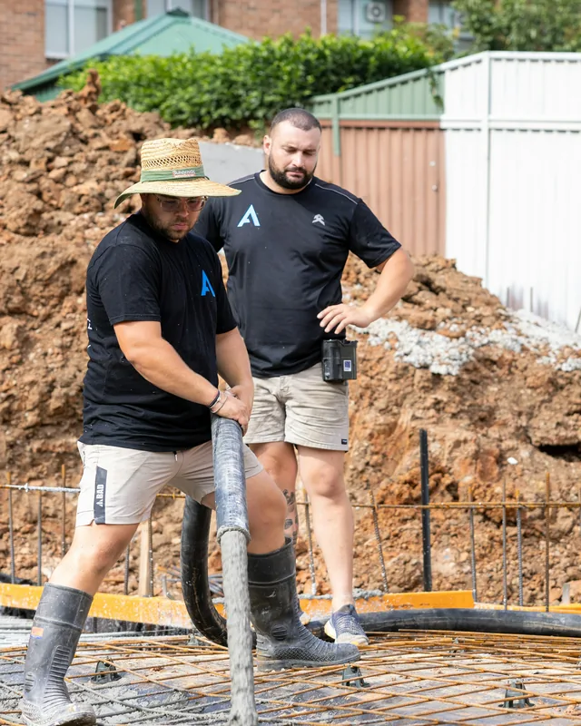 Crew pouring a concrete foundation
